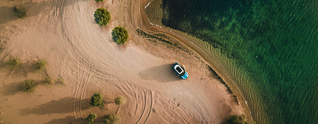 Car driving down beach