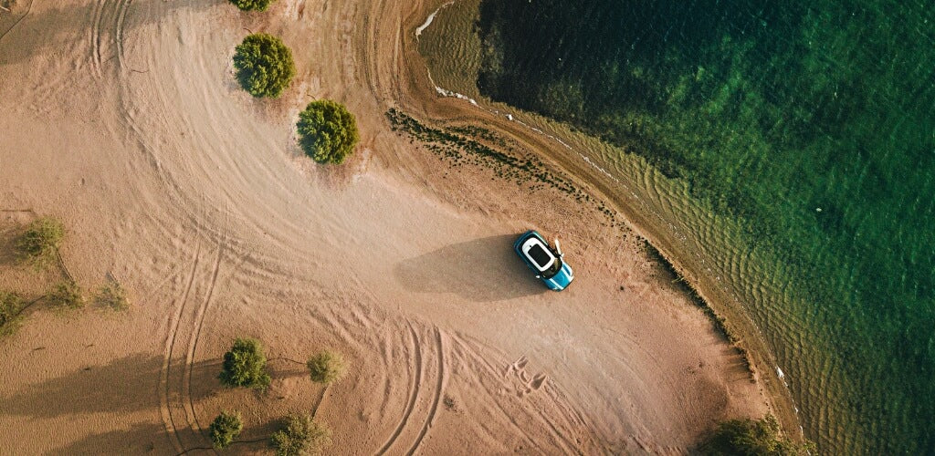 Car driving down beach